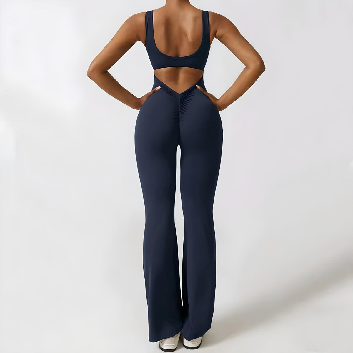 woman wearing stylish black flared jumpsuit with fitted bodice